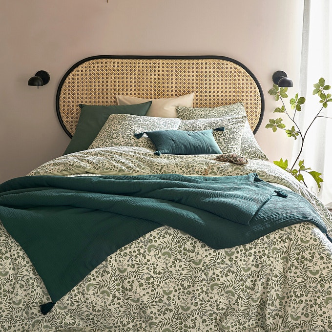 Black and cane rattan headboard from La Redoute. Bed dressed with pretty small floral print bedlinen.
