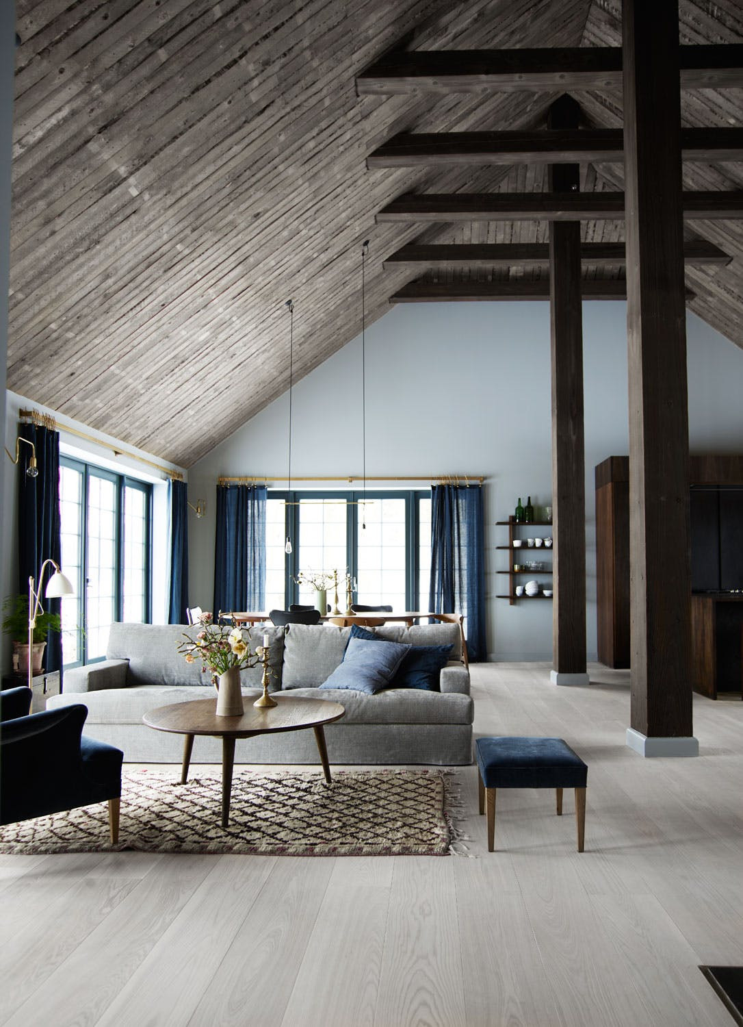 Modern barn inspired Danish home. Open Plan Living space. Rustic Luxe styling with natural timbers, pale blue, and brass detailing