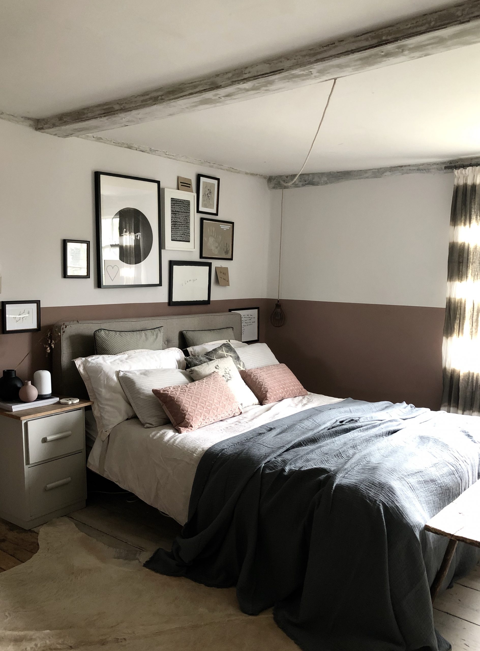 Modern country bedroom makeover. Soft terra cotta half height painted walls, natural linens and gallery wall.