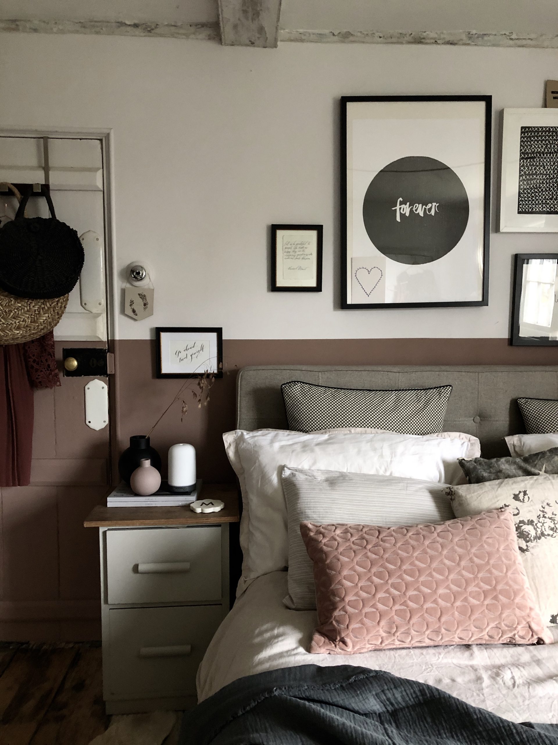 had height wall painted in Paint and Paper Library Rouge II. A dusky pinky terracott shade adds contrast to a light upholstered bed, dressed in natural washed linens.